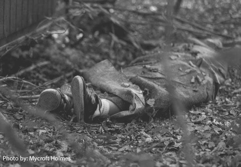 Dead body wrapped in a blanket, for Murder at the Baldwin Ranch